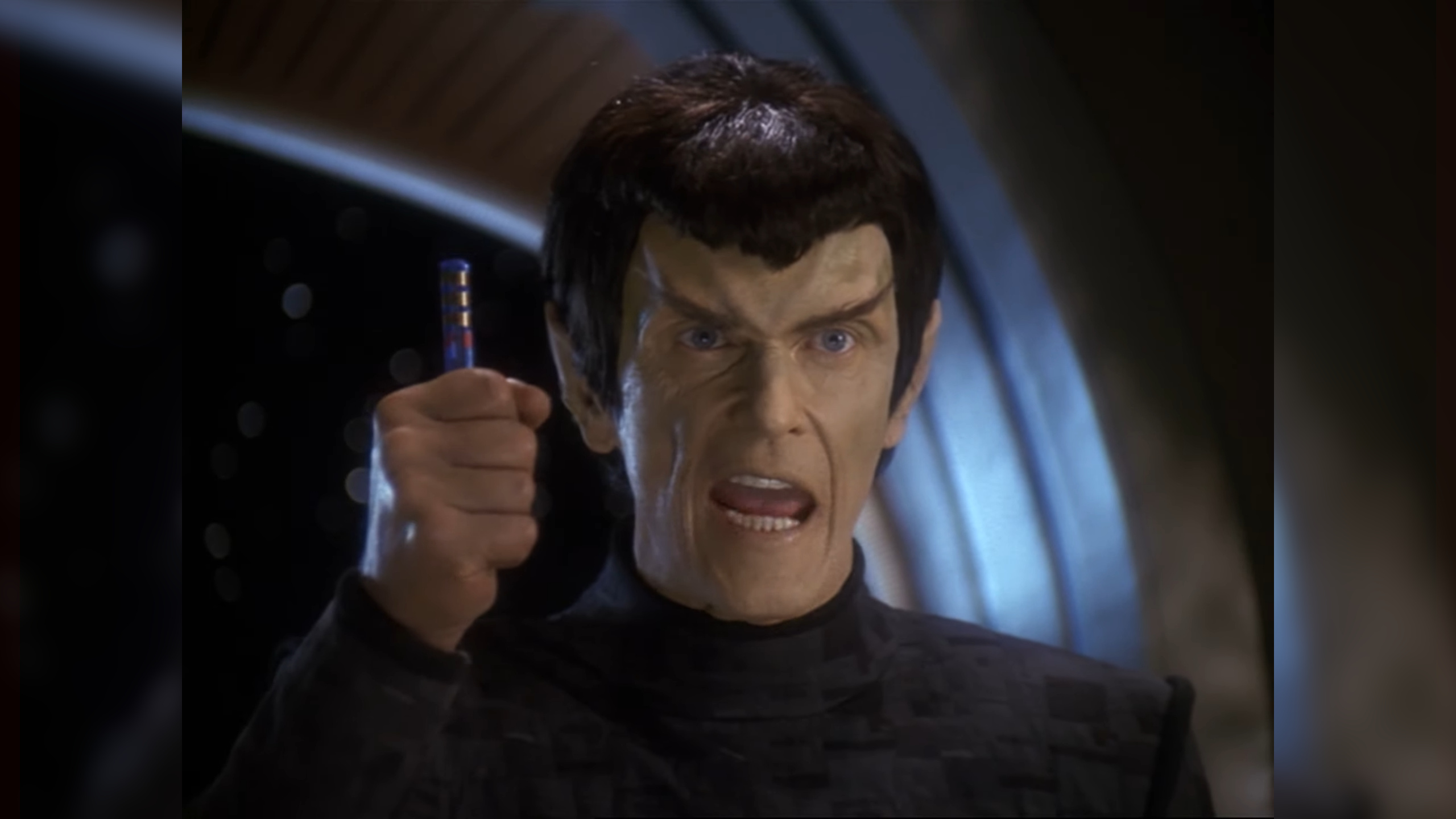 Senator Vreenak from Star Trek: Deep Space Nine holding a padd, captioned It's a fake